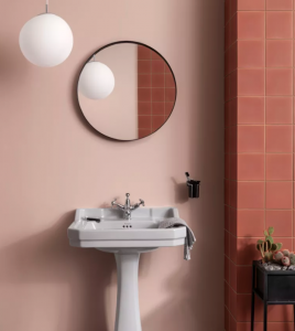 Terracotta and coral bathroom with round mirror and round pendant ceiling light