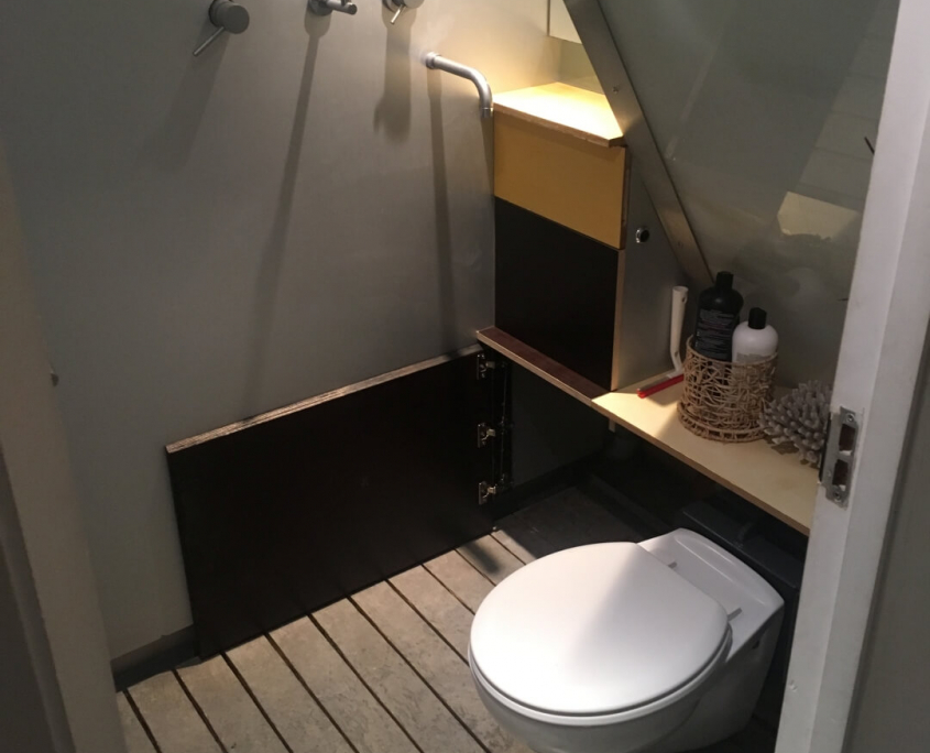 shower wet room created in london with a hidealoo retractable foldaway toilet shown as open. claire installed a hidealoo in her downstairs wetroom. she needed an additional loo and hidealoo was the only solution, creating use of the dead space under the sloping ceiling below a staircase. she’s delighted it doesn’t get wet when showering!